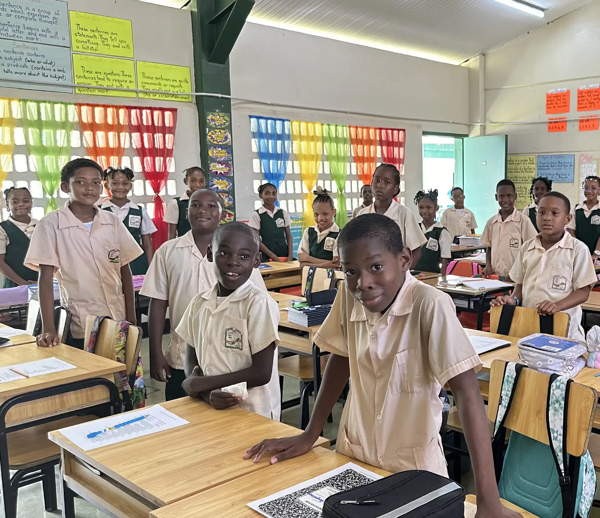 A group of students in a classroom with desks.